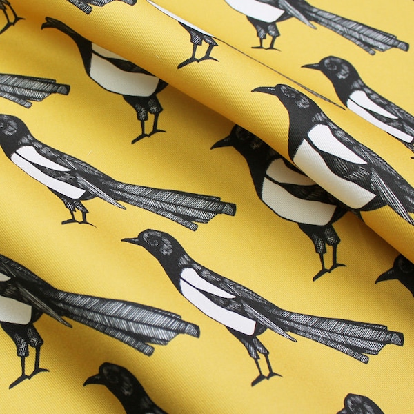 Yellow magpie upholstery fabric available by the metre