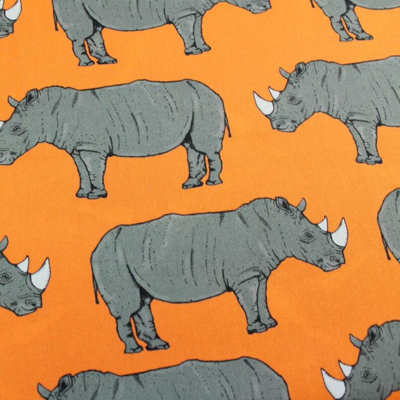Orange Rhino upholstery fabric available by the metre and as Etsy