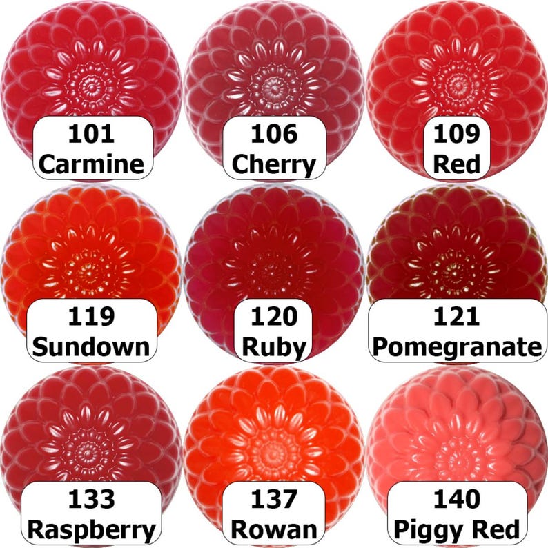 May include: Nine spherical objects in shades of red, from carmine to piggy red, are arranged in a grid. Each sphere has a detailed, flower-like pattern. White labels below each sphere display color names and numbers.