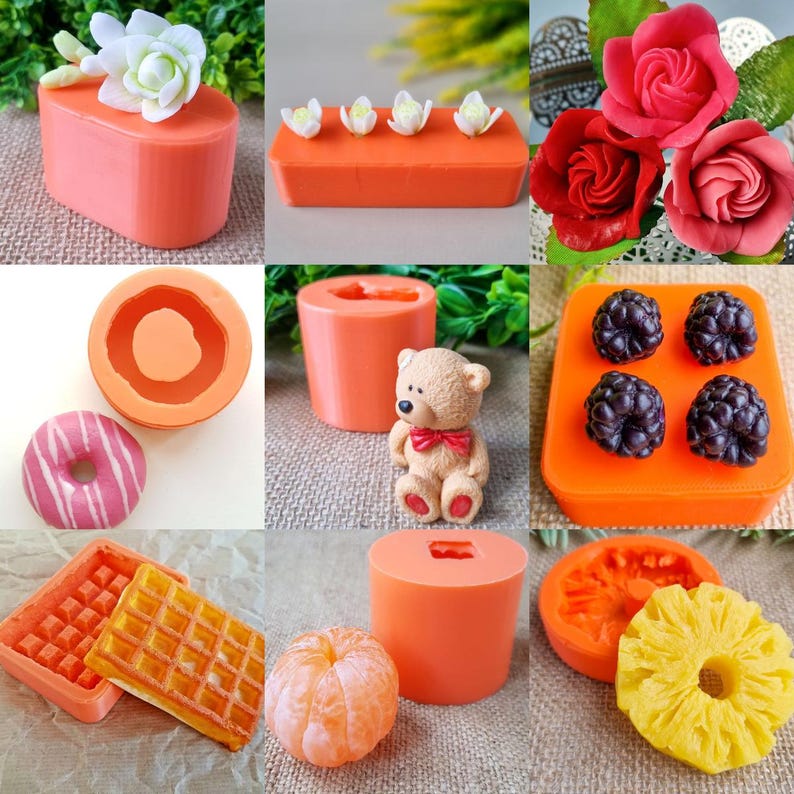 May include: A collection of handmade soaps and molds in various shapes, including flowers, donuts, waffles, and fruit. The soaps are in vibrant colors like pink, orange, and yellow, with detailed textures and designs. A small teddy bear is also present.