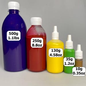 May include: Five bottles of liquid in various sizes and colors. The largest bottle is dark blue and contains 500g (1.1lbs) of liquid. The other bottles are red, yellow, green, and brown, with the smallest containing 10g (0.35oz).