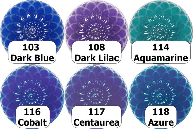 May include: Six decorative glass cabochons in shades of blue, purple, and teal. Each cabochon has a floral design and a white label with a color name and number. Colors include Dark Blue, Dark Lilac, Aquamarine, Cobalt, Centaurea, and Azure.
