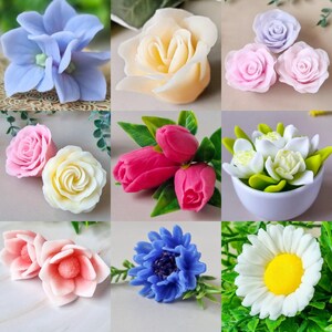May include: A collection of handmade floral soap bars in various colors. The soaps include roses, tulips, daisies, and other flower designs in shades of pink, white, blue, and yellow. The soaps are arranged in a grid pattern.