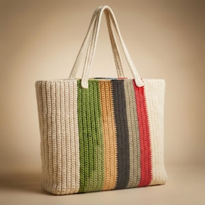 May include: A crochet tote bag featuring vertical stripes in cream, olive green, tan, charcoal gray, and red. The bag has two cream-colored crochet handles attached to the top edge and a textured, ribbed stitch pattern throughout the entire body.