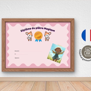 May include: A framed pink certificate with the text "Diplôme du plâtre Magique" and illustrations of deer and a gold medal. A small image of a girl is on the certificate. The frame is brown, and the background is white.