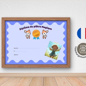 May include: A framed certificate with a light blue background and a wavy border. The certificate features the text "Diplôme du plâtre Magique" and illustrations of deer and a gold medal. A small picture of a girl is on the certificate.