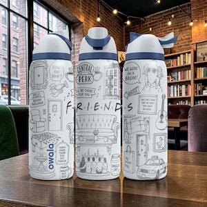 May include: A white Owala water bottle featuring black line art illustrations inspired by the TV show Friends. The design includes iconic imagery like the Central Perk logo, the orange couch, a taxi, and quotes such as How you doin? and We were on a break.
