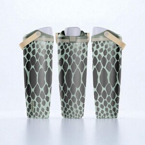 May include: Three views of an Owala water bottle featuring a light mint green base with a dark gray giraffe-like spot pattern. The bottle has a white lid, a dark gray cap, and a beige carry loop. The brand name Owala is printed on the lower side.