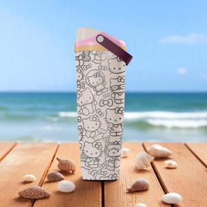 May include: A white water bottle featuring a repeating black outline pattern of Hello Kitty characters. The bottle has a pink and brown handle and lid. The background shows a beach scene with seashells on a wooden surface.