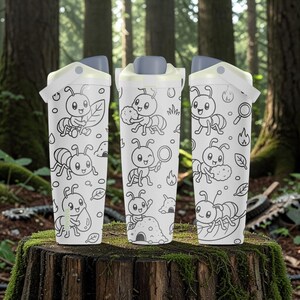 May include: Three white tumblers with a grey lid and handle, featuring a black line art pattern of cartoon ants, leaves, magnifying glasses, and fire icons. The ants are depicted in various activities, including holding objects and interacting with nature.