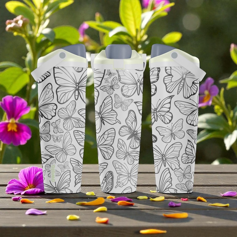 May include: Three white water bottles with a butterfly pattern. The bottles have gray lids and white handles. The background includes flowers and a wooden surface.