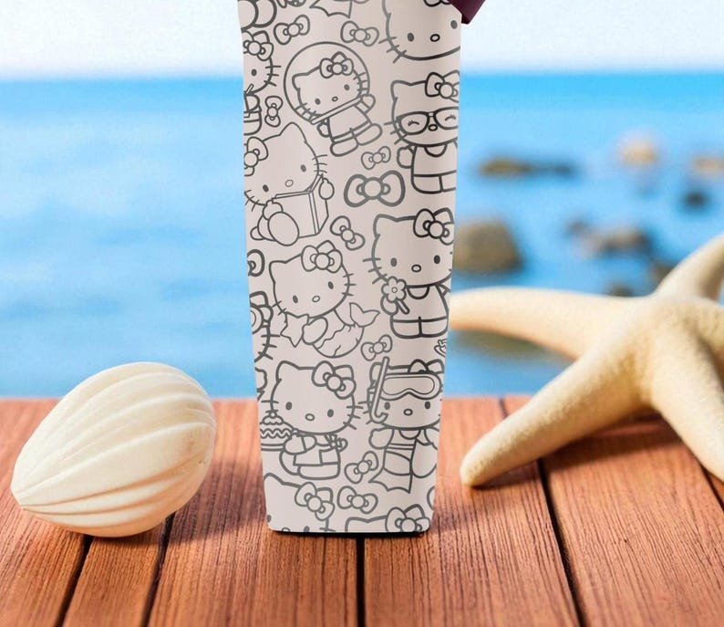 May include: A white tumbler featuring a repeating black and white pattern of Hello Kitty characters in various poses. The tumbler is set on a wooden surface with a seashell and starfish in the background.