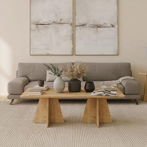 May include: A set of three ceramic mugs with a speckled, matte finish. The mugs are in shades of cream, light gray, and dark gray. Each mug has a simple, minimalist design and a rounded handle. The mugs are likely for coffee or tea.