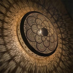 May include: A set of three ceramic mugs with a speckled, matte finish. The mugs are in shades of cream, light gray, and dark gray. Each mug has a simple, minimalist design and a rounded handle.