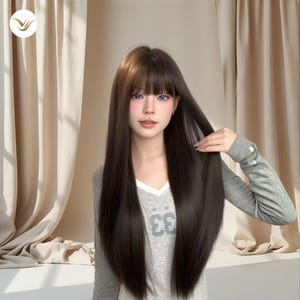 May include: A long, dark brown wig with bangs. The wig is styled with straight, sleek hair. The person is wearing a gray long-sleeved shirt with the number "33" printed on the front.