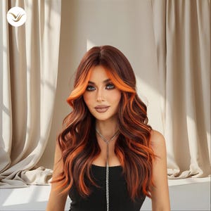 May include: A woman with long, wavy auburn hair with bright orange highlights. The hair frames the face and shoulders. She is wearing a black top and a silver necklace. The background features neutral-toned curtains.