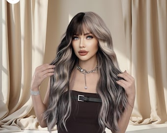 May include: A long, wavy wig with a two-tone design. The wig features a black and ash blonde color scheme with a fringe. The model is wearing a dark brown strapless top and a silver necklace.