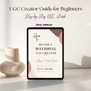 May include: A digital tablet displays the title "How to Become a Successful UGC Creator" with the text "UGC Creator Guide for Beginners" and "Step-by-Step UGC eBook." The ebook is a digital download. A beige vase is in the background.