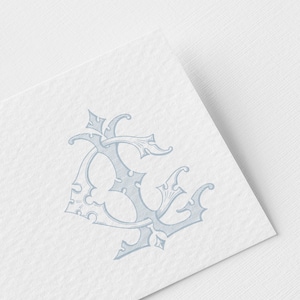 May include: A light blue, ornate monogram design featuring the intertwined letters "E" and "C" on a white textured background. The design has a vintage, elegant aesthetic, with decorative flourishes and a detailed, engraved appearance.