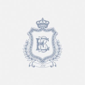 May include: A light blue heraldic crest design featuring a crown, shield, and laurel branches. The shield displays the intertwined letters "KB" in a stylized font. A banner at the bottom reads "2026".