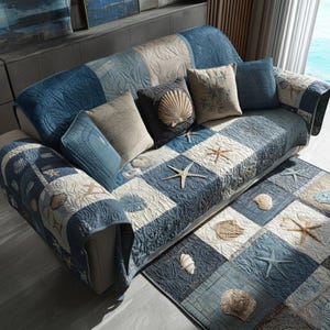 May include: A blue and white quilted sofa cover and matching rug set. The set features a patchwork design with seashell and starfish motifs. Includes several throw cushions with seashell and starfish designs.