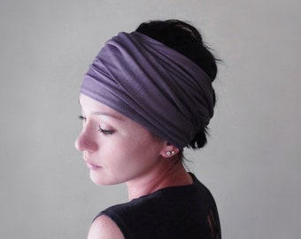 May include: A wide, solid mauve-colored fabric headband featuring a gathered, ruched design that wraps around the head. The accessory is made of a soft, stretchy material and provides full coverage across the forehead and crown of the head.