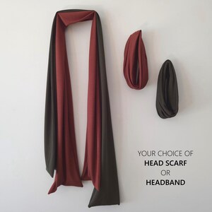 May include: A head scarf or headband in shades of red and dark olive green. The image shows a long scarf draped on a white wall, with two headbands in the same colors. Text on the right reads "YOUR CHOICE OF HEAD SCARF OR HEADBAND."