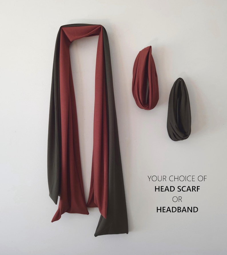 May include: A head scarf or headband in shades of red and dark olive green. The image shows a long scarf draped on a white wall, with two headbands in the same colors. Text on the right reads "YOUR CHOICE OF HEAD SCARF OR HEADBAND."