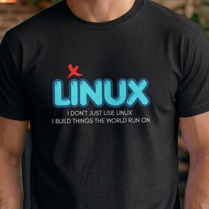 May include: Black t-shirt with the word "LINUX" in blue, outlined in a lighter blue, and a red "X" above it. Below the word "LINUX" is the text "I DON'T JUST USE LINUX I BUILD THINGS THE WORLD RUN ON."