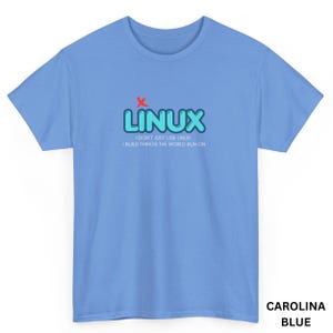 May include: Carolina blue t-shirt with the word "LINUX" in light blue bubble letters and a red "x" above the word. Below the word "LINUX" is the text "I DON'T JUST USE LINUX I BUILD THINGS THE WORLD RUN ON."