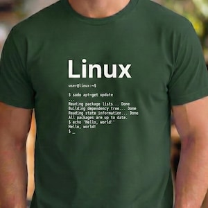 May include: Dark green t-shirt with the word "Linux" in white block letters. Below the word "Linux" is a command-line interface with text including "sudo apt-get update" and "Hello, world!".