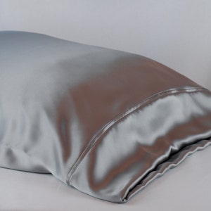 May include: A silver satin pillowcase. The pillowcase is smooth and wrinkle-free.
