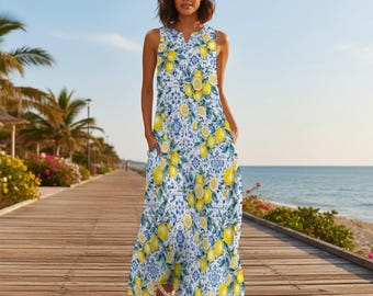 May include: Sleeveless maxi dress with a vibrant lemon and blue floral pattern. The dress features a V-neckline and pockets. The fabric is a light, flowing material, perfect for warm weather. The dress is a stylish and comfortable choice for casual outings.