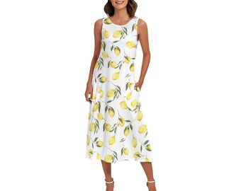 May include: A sleeveless, midi-length dress with a white backdrop and a repeating pattern of yellow lemons and green leaves. The dress has a scoop neckline and pockets. The model is wearing white sandals.
