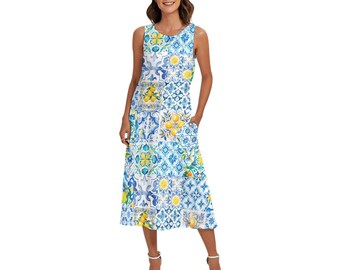May include: Sleeveless midi dress featuring a patchwork design with blue, white, and yellow patterns. The dress includes a variety of floral and lemon motifs. It has a round neckline and two pockets. The dress is knee-length and made of a lightweight fabric.