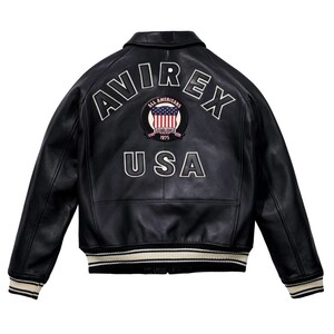 May include: Black leather jacket with the word "AVIREX" arched across the shoulders in white lettering. Below the word "AVIREX" is a patch with the American flag and the words "ALL AMERICANS ESTABLISHED 1975". The word "USA" is below the patch.