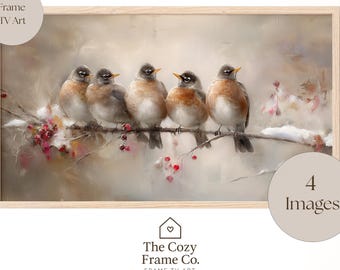 May include: A framed digital art print depicting six small birds on a snow-covered branch with red berries. The artwork has a soft, muted colour palette and the text "THE COZY FRAME" is at the top.