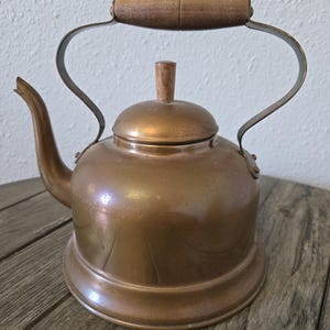 May include: A set of three ceramic mugs with a speckled, matte finish. The mugs are in shades of cream, light gray, and dark gray. Each mug has a simple, minimalist design, perfect for coffee or tea.