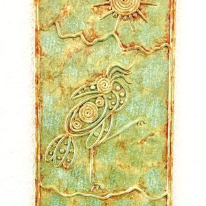 May include: A rectangular, textured wall art piece with a bird and sun design. The artwork features a green and brown colour palette with a raised relief design. The bird is depicted with a long beak and is standing on one leg. The sun has a spiral design.