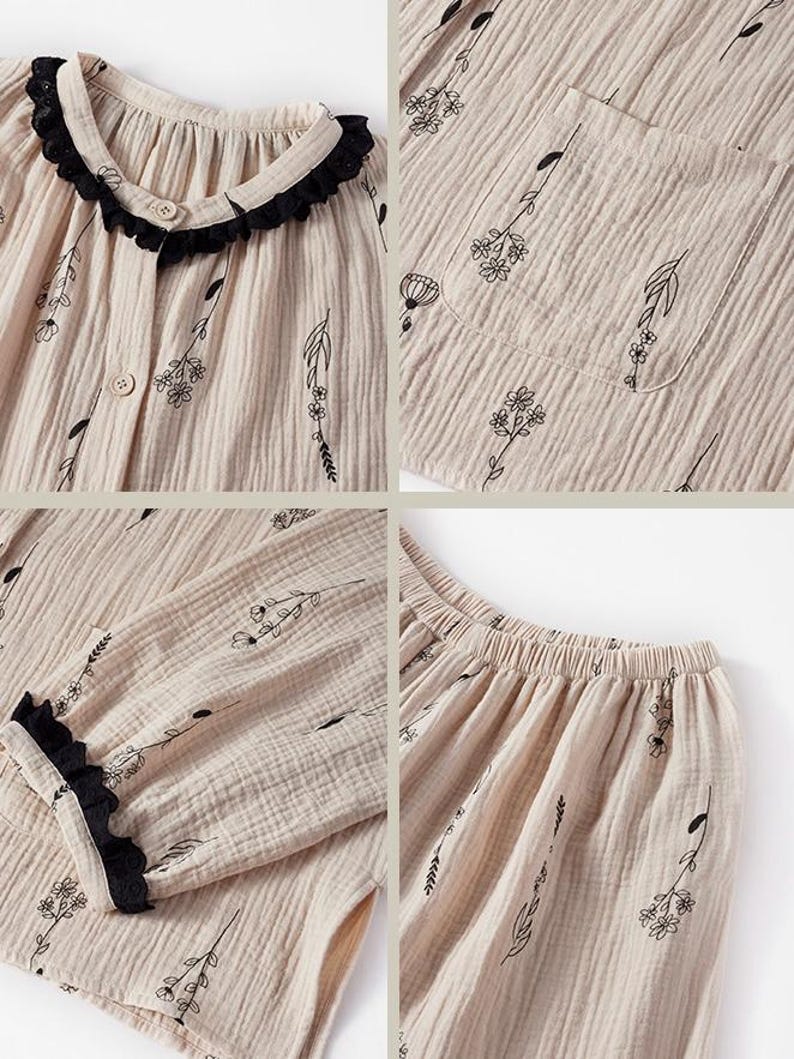 May include: Beige pajama set with a floral pattern. The top has a round collar with black lace trim and button closure. The long-sleeved top and pants feature a delicate black floral design. The fabric has a textured, crinkled appearance.