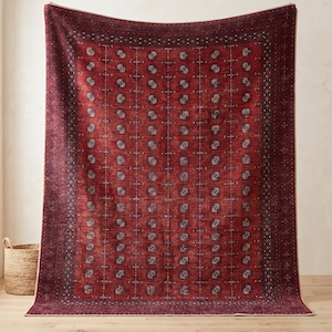 May include: A large rectangular area rug featuring a deep red base color with a repeating pattern of dark circular motifs and vertical geometric lines. The rug has a wide, dark border with intricate detailing and a light-colored edge trim.