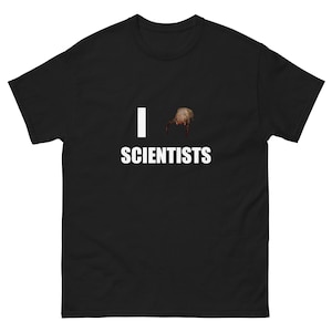 May include: Black t-shirt featuring the text "I <3 SCIENTISTS" in white, with a headcrab graphic replacing the heart. The shirt is made of a heavy cotton fabric. A humorous design.
