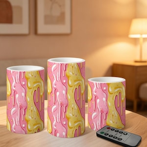 May include: A set of three ceramic mugs with a speckled, matte finish. The mugs are in shades of cream, light gray, and dark gray. Each mug has a simple, minimalist design and a rounded handle.