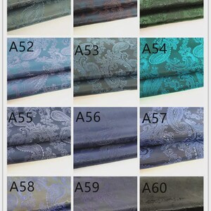 May include: A grid of fabric swatches with paisley patterns in various colors. The swatches are labeled A49 through A60. Colors include teal, brown, green, blue, and navy. The fabric has a sheen.