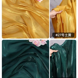 May include: Close-up of two sections of fabric, one gold and one dark green, with soft folds and a slight sheen. The gold fabric has a floral accent. The dark green fabric has the text "#28" and Chinese characters. The gold fabric has the text "#27" and Chinese characters.