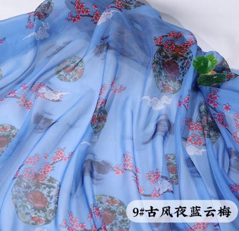 May include: Light blue fabric with a floral pattern featuring red flowers and green accents. The fabric has a semi-transparent quality, with a design that includes circular motifs and cloud-like shapes. Text in the lower right corner reads "9# ancient style blue cloud plum".