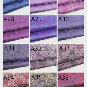 May include: A collection of nine fabric swatches, each showcasing a different color and paisley pattern. Colors range from blues and purples to burgundy and gray. Each swatch is labeled with a letter and number combination.