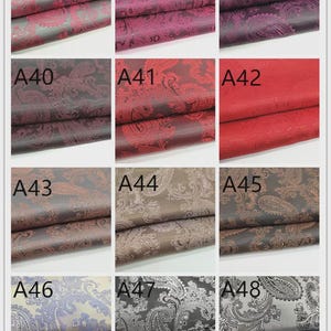 May include: A grid of nine fabric swatches, each displaying a different color and pattern. The fabrics feature a paisley design in shades of red, burgundy, brown, and gray. Each swatch is labeled with a number, ranging from A37 to A48.
