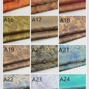 May include: A collection of paisley patterned fabric swatches in various colors, including red, gold, brown, and blue. Each swatch is labeled with a number, showcasing the different color options available for the fabric.