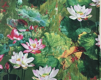 May include: A green and brown fabric with a floral pattern featuring pink and white lotus flowers. The fabric has a textured, watercolor-like appearance.